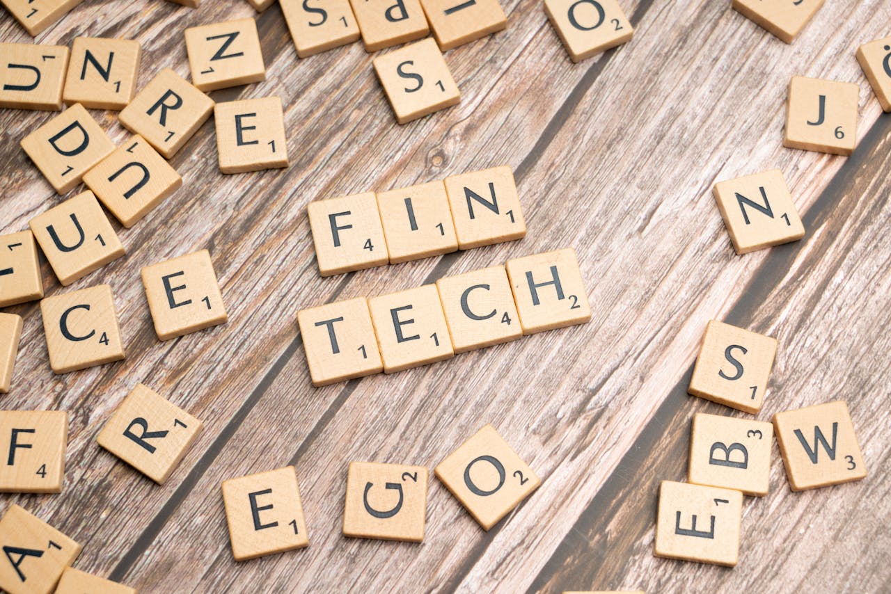 why-choose-us Fintech spelled out with wooden letter tiles on a rustic wooden background.