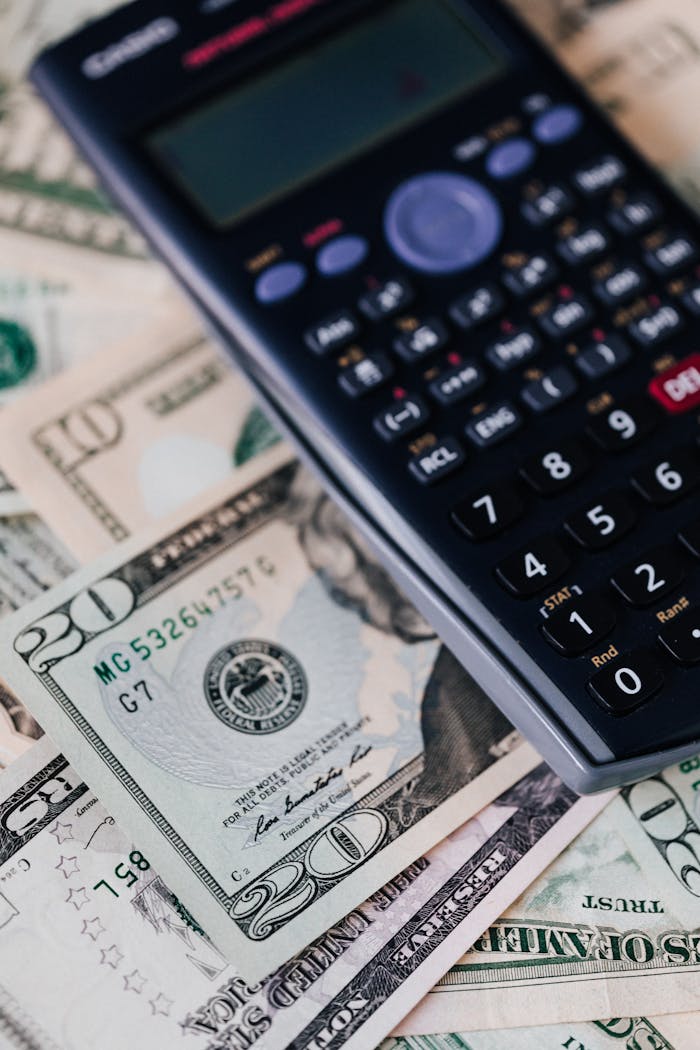 about-02 From above of calculator placed on paper banknotes of American dollars on table